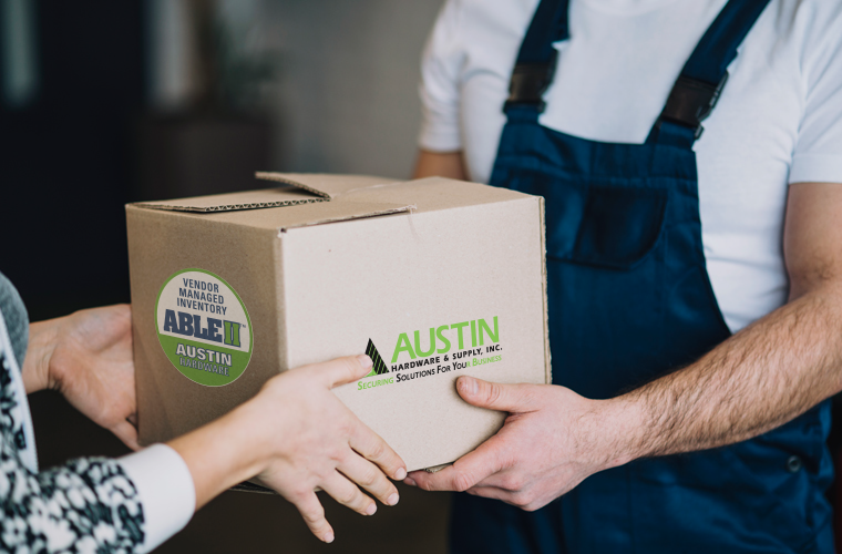 674a122588143-vmi-employee-with-box.png